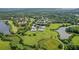 Aerial view of community with lake, lush landscape, and residential buildings at 717 Glasgow Ct, Winter Springs, FL 32708