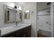 Modern bathroom with dark vanity and updated fixtures at 717 Glasgow Ct, Winter Springs, FL 32708