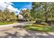 Attractive community entrance with landscaping and circular driveway at 717 Glasgow Ct, Winter Springs, FL 32708