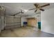 Attached garage with storage shelving and ceiling fan at 717 Glasgow Ct, Winter Springs, FL 32708