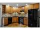 Modern kitchen with wood cabinets, stone backsplash, and concrete floors at 717 Glasgow Ct, Winter Springs, FL 32708