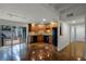 Modern kitchen with stained concrete floors, wood cabinets, and black appliances at 717 Glasgow Ct, Winter Springs, FL 32708