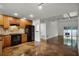 Modern kitchen with wood cabinets, stone backsplash, and concrete floors at 717 Glasgow Ct, Winter Springs, FL 32708