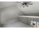 Bright loft bedroom with wood floors and ceiling fan at 717 Glasgow Ct, Winter Springs, FL 32708