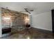 Main bedroom with stone feature wall and polished concrete floors at 717 Glasgow Ct, Winter Springs, FL 32708