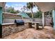 Outdoor kitchen with built-in grill and stone countertops at 717 Glasgow Ct, Winter Springs, FL 32708