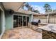 Patio with outdoor kitchen and stone tile flooring at 717 Glasgow Ct, Winter Springs, FL 32708