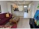 Living room with burgundy couches, coffee table, and view into kitchen at 800 Woodlark Dr, Davenport, FL 33897