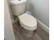 Simple toilet and flooring in a small bathroom at 8421 S Orange Blossom Trl # 321, Orlando, FL 32809