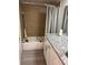 Bathroom with tub, granite vanity, and gray flooring at 8421 S Orange Blossom Trl # 321, Orlando, FL 32809