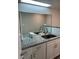 Bathroom boasts a double vanity with granite countertop at 8421 S Orange Blossom Trl # 321, Orlando, FL 32809