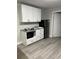 Small kitchen with microwave, cabinets, and granite countertops at 8421 S Orange Blossom Trl # 321, Orlando, FL 32809