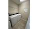 Laundry room with washer, dryer, and shelving at 8692 Wellington Blue Ln, Windermere, FL 34786