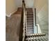 Carpeted staircase with dark wood railing at 8692 Wellington Blue Ln, Windermere, FL 34786