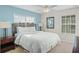 Bright bedroom with a king-size bed, nightstands, and window coverings at 8925 Candy Palm Rd, Kissimmee, FL 34747