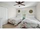 Bedroom with two twin beds, ceiling fan, and dresser at 8925 Candy Palm Rd, Kissimmee, FL 34747