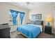 Bedroom with a double bed, blue bedding, and a ceiling fan at 8925 Candy Palm Rd, Kissimmee, FL 34747