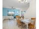 Bright dining room with white table and wooden chairs at 8925 Candy Palm Rd, Kissimmee, FL 34747