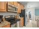 Kitchen with stainless steel appliances and granite countertops at 8925 Candy Palm Rd, Kissimmee, FL 34747