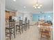 Open concept kitchen and dining area with island and breakfast bar at 8925 Candy Palm Rd, Kissimmee, FL 34747