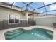 Private screened pool and patio with steps and furniture at 8925 Candy Palm Rd, Kissimmee, FL 34747