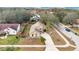 Aerial view of a single-story home featuring mature landscaping, spacious driveway, and lush trees at 905 Hatteras Ave, Minneola, FL 34715