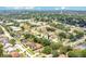 Wide aerial shot showcasing a neighborhood with mature trees and well-maintained homes at 905 Hatteras Ave, Minneola, FL 34715