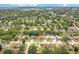 Overhead aerial view of a neighborhood with lush trees and residential homes at 905 Hatteras Ave, Minneola, FL 34715