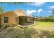 Great backyard featuring mature landscaping and a screened-in porch at 905 Hatteras Ave, Minneola, FL 34715