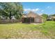 Spacious backyard featuring a screened-in patio, wood fence, and ample green space at 905 Hatteras Ave, Minneola, FL 34715