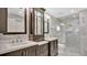 Elegant bathroom with double vanity, marble tile, and a large shower at 905 Hatteras Ave, Minneola, FL 34715