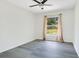 Cozy bedroom with large window, neutral walls, and stylish gray flooring at 905 Hatteras Ave, Minneola, FL 34715
