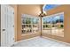 Sunny dining room with tile floors, large windows offering neighborhood views and modern chandelier at 905 Hatteras Ave, Minneola, FL 34715