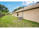 Side view of home showing exterior siding, landscaping, and an air conditioning unit at 905 Hatteras Ave, Minneola, FL 34715