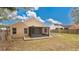 Back exterior of house, showcasing a screened porch and yard at 905 Hatteras Ave, Minneola, FL 34715