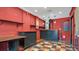 Image shows an interior room with red walls, checkered floors, and a built-in bar at 905 Hatteras Ave, Minneola, FL 34715