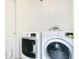 Bright laundry room featuring an LG washer and dryer with a utility door at 905 Hatteras Ave, Minneola, FL 34715