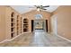 Bright and airy living room boasts tile flooring, built-in shelving, and sliding glass doors to the lanai at 905 Hatteras Ave, Minneola, FL 34715