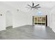 Bright living room with high ceilings, modern ceiling fan, and sliding glass doors to the outdoor patio at 905 Hatteras Ave, Minneola, FL 34715