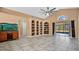 Bright living room with built-in shelving, tile floors, and a sliding glass door at 905 Hatteras Ave, Minneola, FL 34715