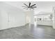 Large, open living room with neutral paint, gray laminate flooring, and plenty of natural light at 905 Hatteras Ave, Minneola, FL 34715