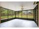 Screened-in porch with tile floor, ceiling fan and views of the fenced backyard at 905 Hatteras Ave, Minneola, FL 34715