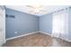 Simple bedroom with gray walls, wood flooring, and a window at 4089 Sw 133Rd Loop, Ocala, FL 34473