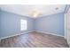 Light and airy bedroom with gray walls and wood-look floors at 4089 Sw 133Rd Loop, Ocala, FL 34473