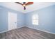 Spacious bedroom with light blue walls and wood-look flooring at 4089 Sw 133Rd Loop, Ocala, FL 34473