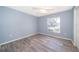 Spacious bedroom with light gray walls and wood-look flooring at 4089 Sw 133Rd Loop, Ocala, FL 34473