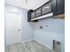 Bright laundry room with modern cabinets and tile floor at 4089 Sw 133Rd Loop, Ocala, FL 34473