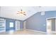 Open living area with vaulted ceiling and barn doors at 4089 Sw 133Rd Loop, Ocala, FL 34473