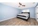 Main bedroom with gray walls, wood flooring, and a king-size bed at 4089 Sw 133Rd Loop, Ocala, FL 34473