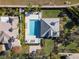 Aerial view of the home showcasing a private pool, patio, and palm trees at 10812 Woodchase Cir, Orlando, FL 32836